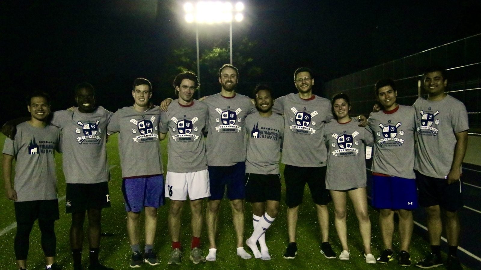 GHD soccer team smiling and wearing grey champion shirts