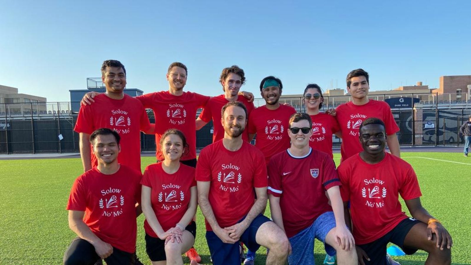 GHD soccer team posing on the field wearing their red jerseys