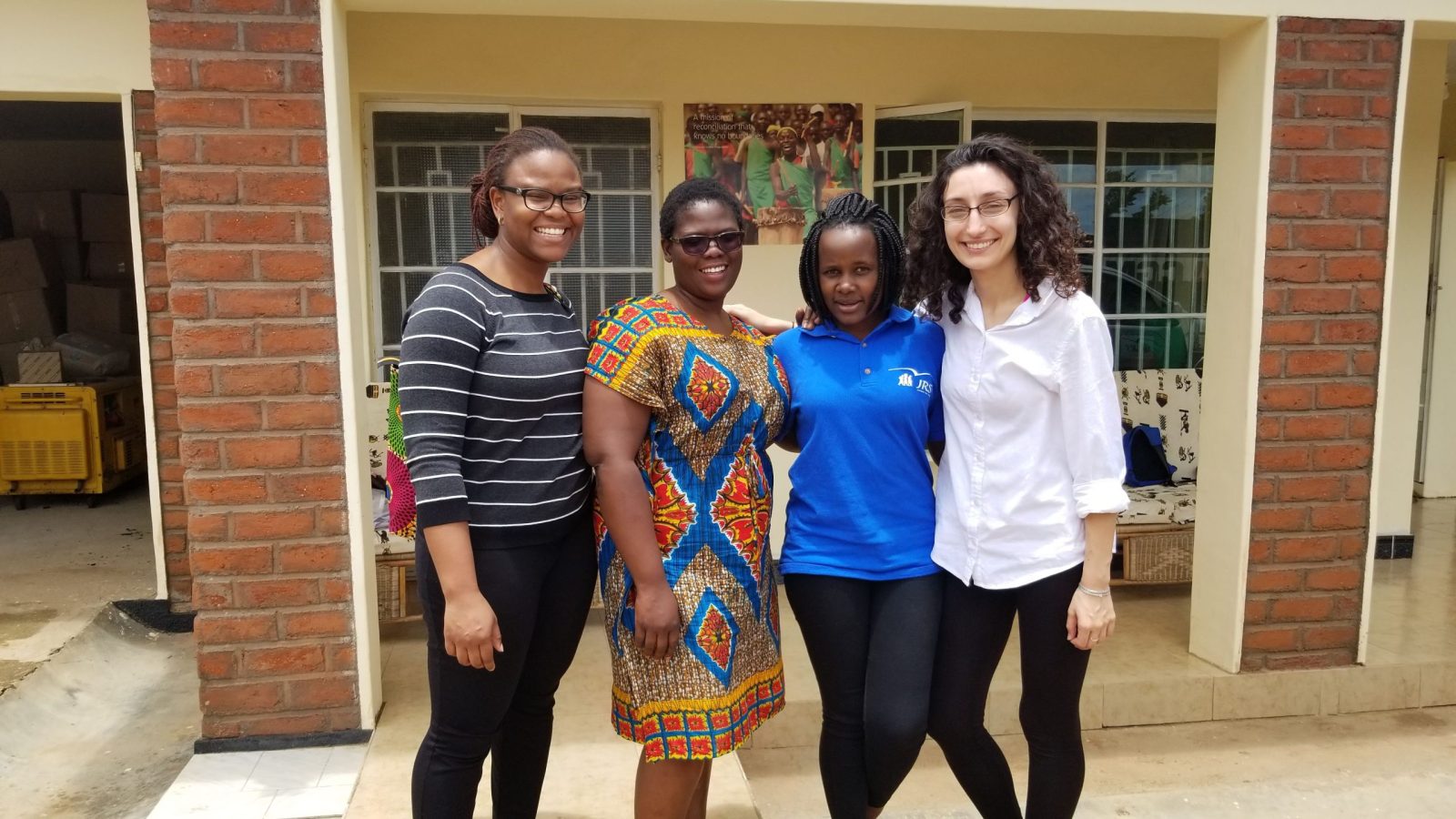 Foluyinka and three other women standing outside in front of a building in Malawi