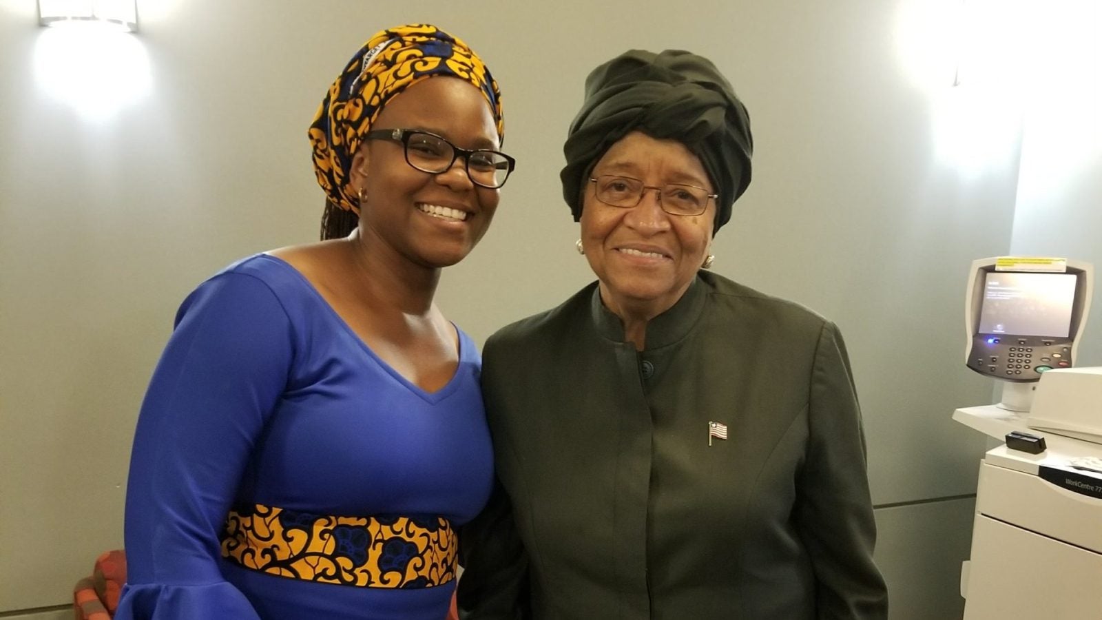 Yoluyinka standing with Ellen Johnson Sirleaf