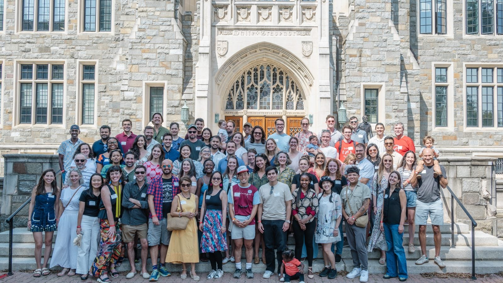 Alumni of the Global Human Development Program standing in front of White-Gravenor Hall.