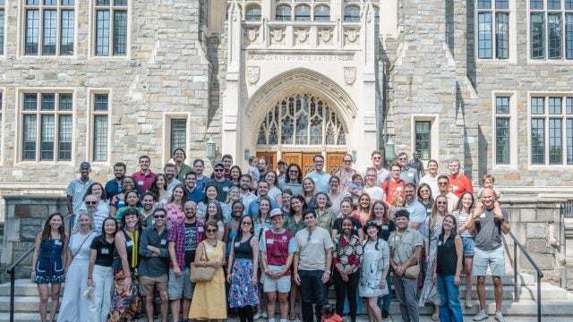 Alumni of the Global Human Development Program standing in front of White-Gravenor Hall.