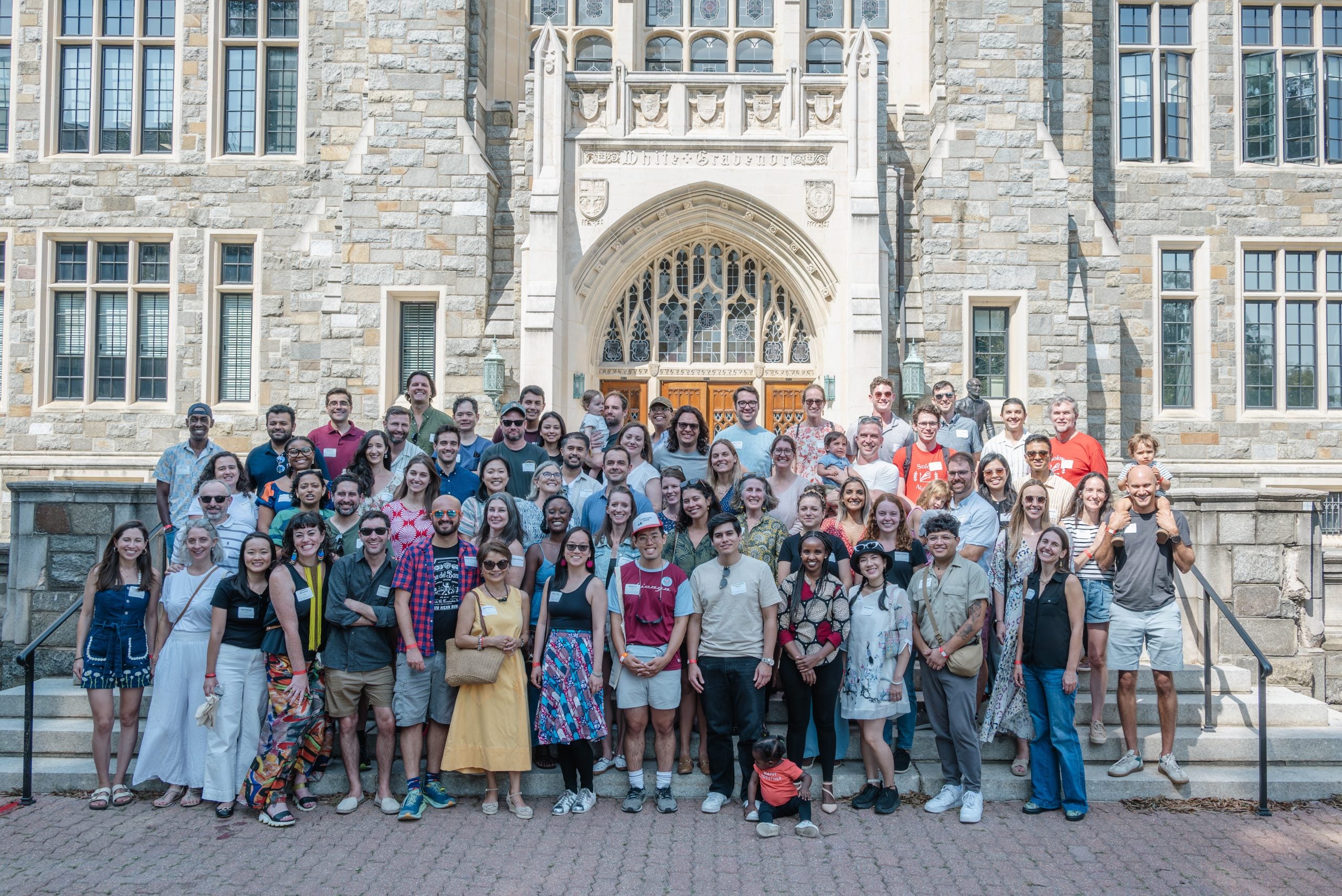 Alumni of the Global Human Development Program standing in front of White-Gravenor Hall.